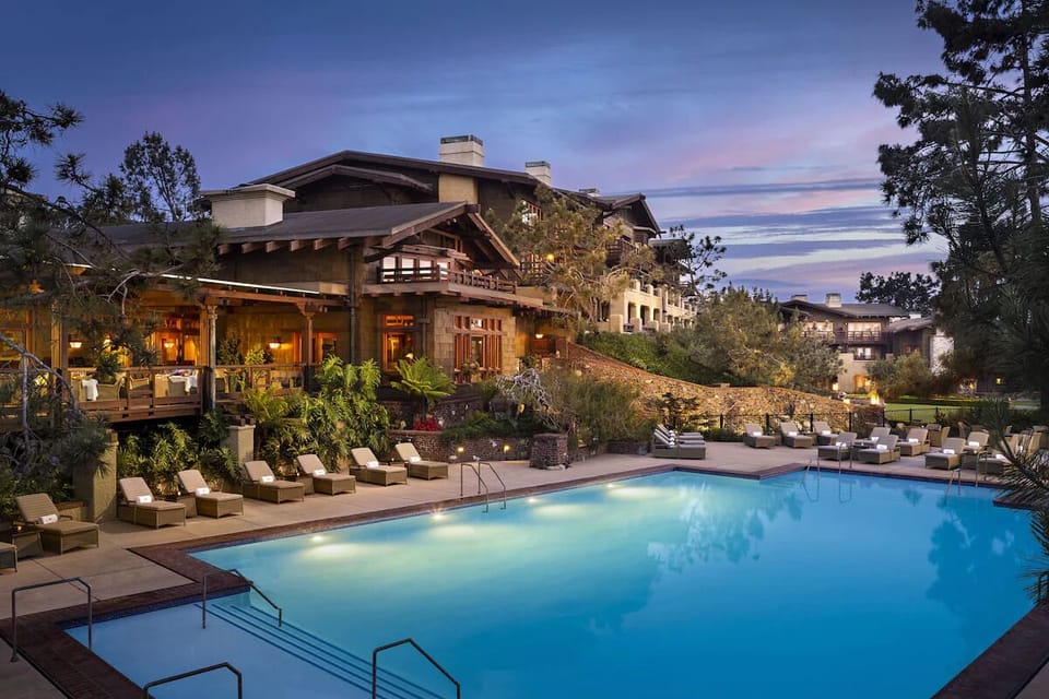 Unwind poolside at dusk with glowing lights and loungers.