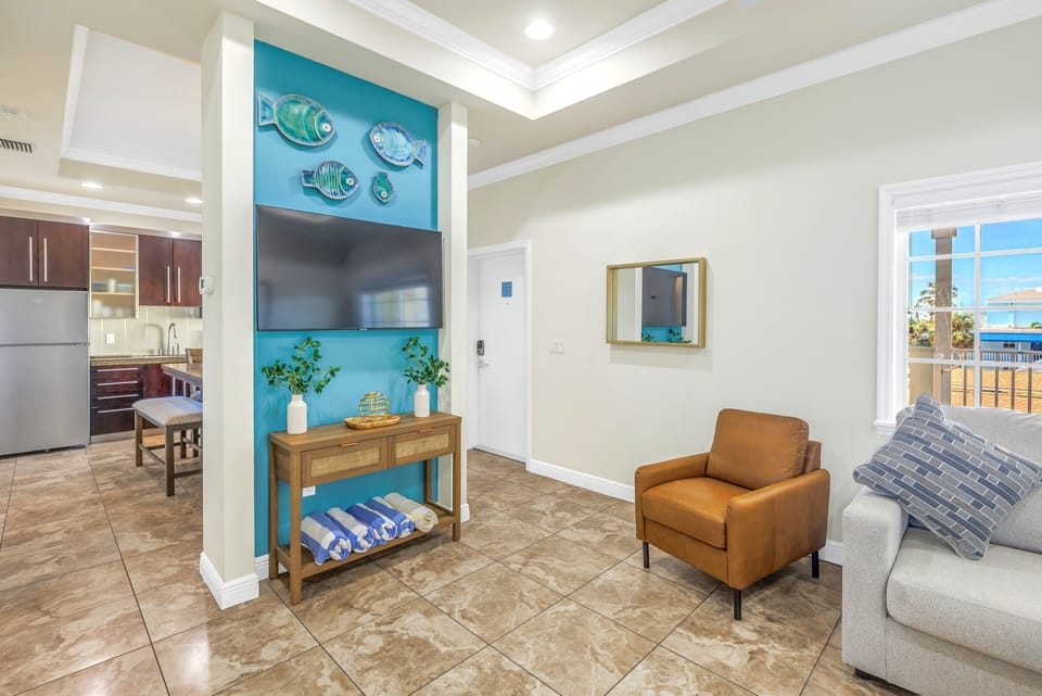 Open sunny living area leading to kitchen.