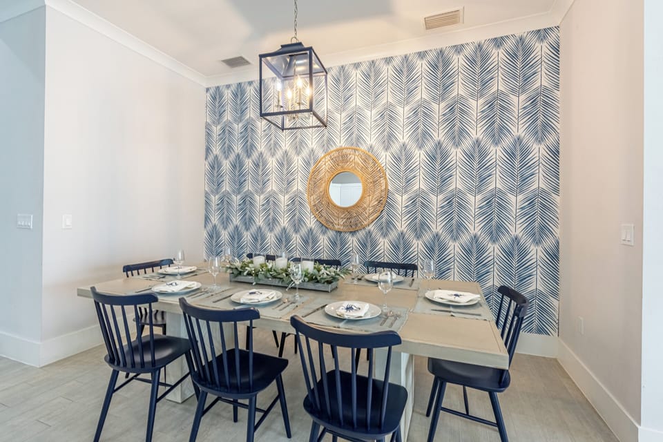 Gather around this beautiful 8-seater dining table, perfect for family feasts and fun meals with friends! Enjoy great conversations and delicious food in this inviting space! | Seaside Sanctuary, Naples, Florida | Voyax Luxury Vacation Rentals