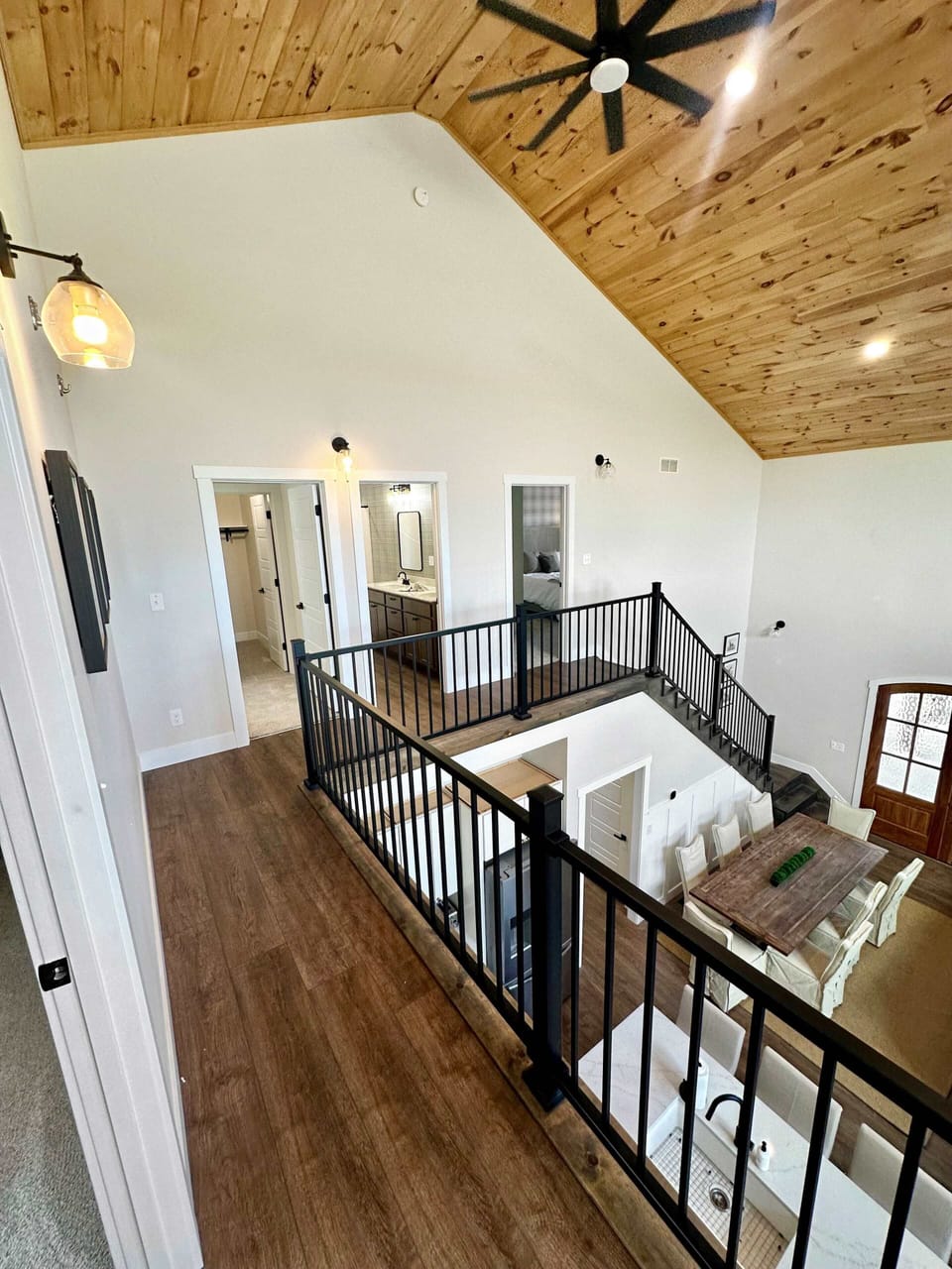 Stylish home with vaulted wood ceilings and open railings overlooking the kitchen and dining area. Bright, airy, and ideal for gatherings or a peaceful getaway.