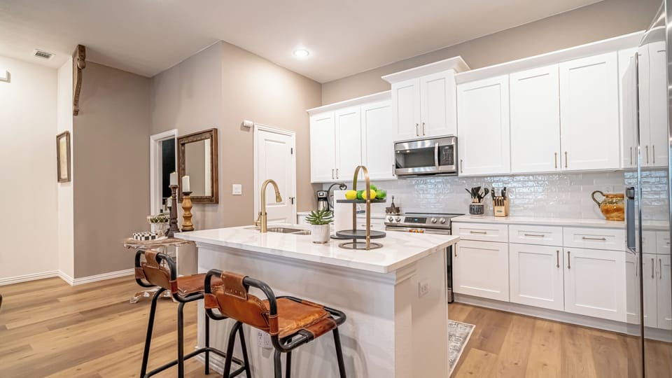 The kitchen is a modern, fully-equipped space with sleek countertops and all the essentials, perfect for preparing everything from quick snacks to full meals.