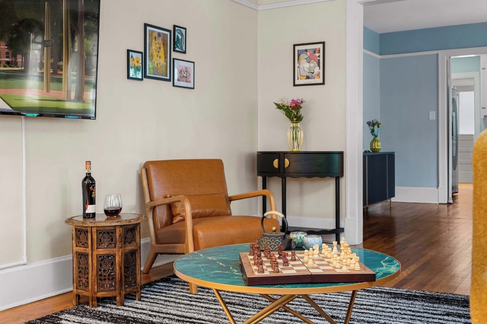 Relaxing seating area with leather chairs, chess, and unwind.