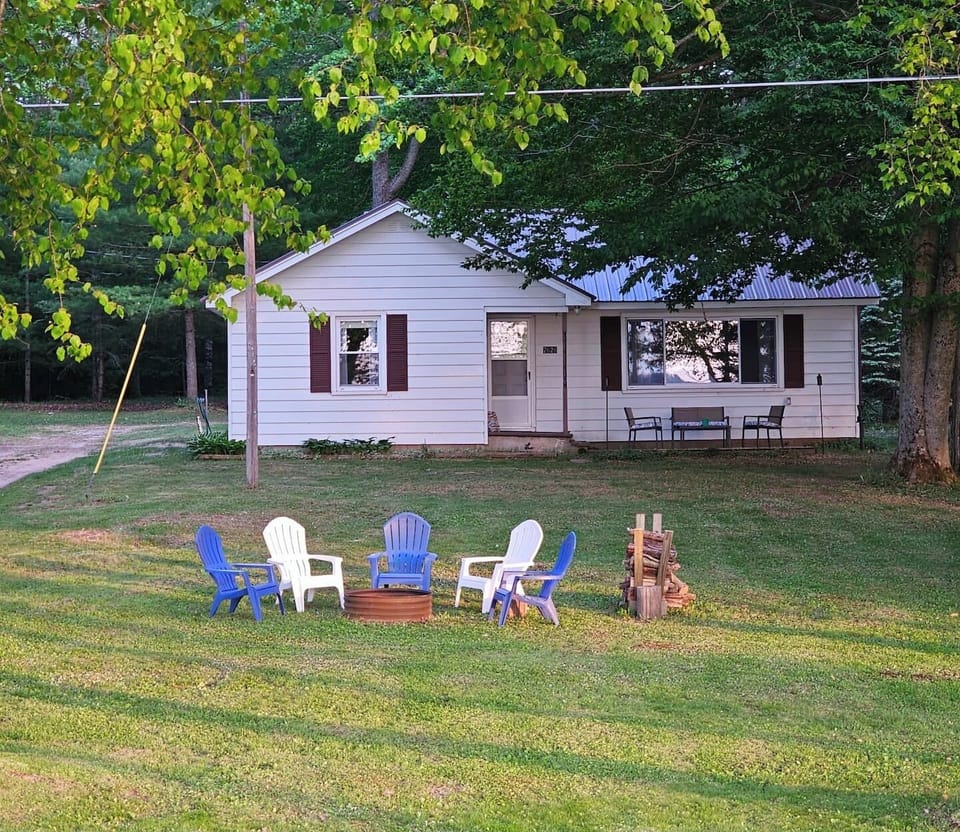 OVERALL:  The front of the cabin in summer with the private bonfire ring in the front yard.