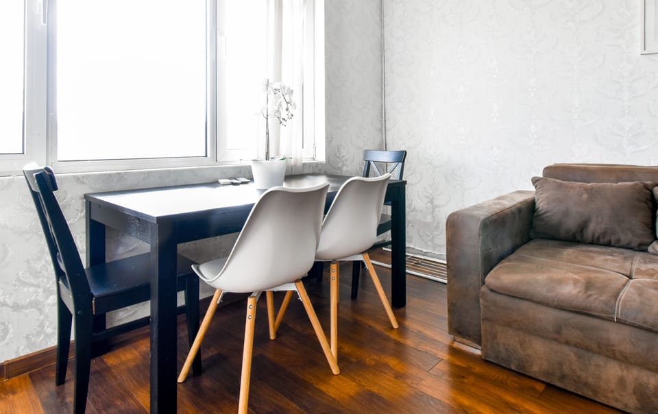 Cozy dining space with natural light—perfect for meals or working remotely. Book now!