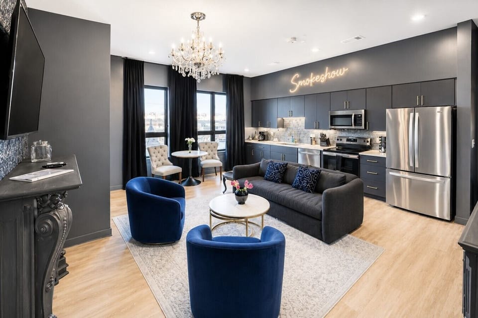 Open floor plan living and kitchen area with sofa bed, Smart TV, and patio access.