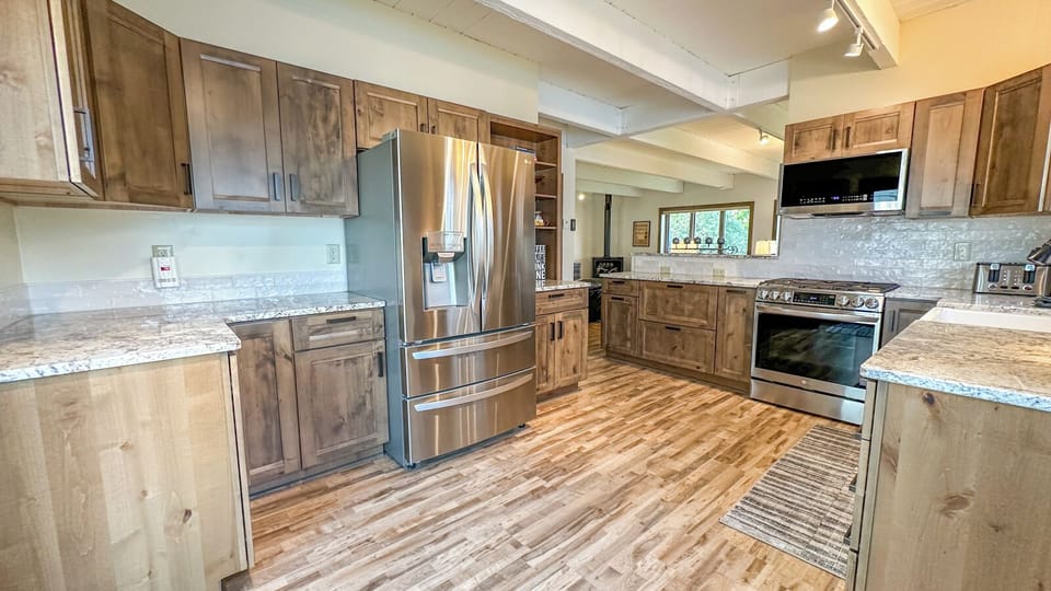 The chef's kitchen boasts granite countertops and high-end stainless steel appliances.
