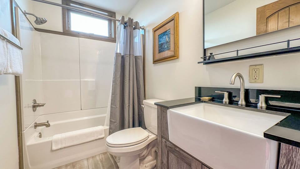 The second bathroom, located in the bedroom hallway, has a shower/tub combo.
