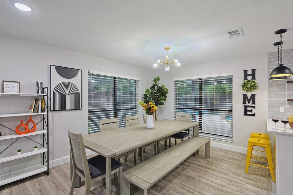 A bright and modern kitchen with sleek finishes, stylish pendant lighting, and a cozy breakfast bar. The open layout flows into the dining area, creating the perfect space for cooking, dining, and entertaining.