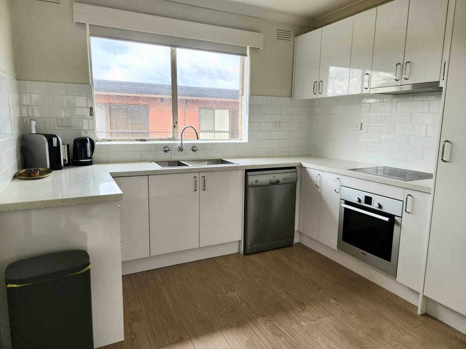Full kitchen with fridge, freezer, dishwasher, oven, stove, cutlery, crockery