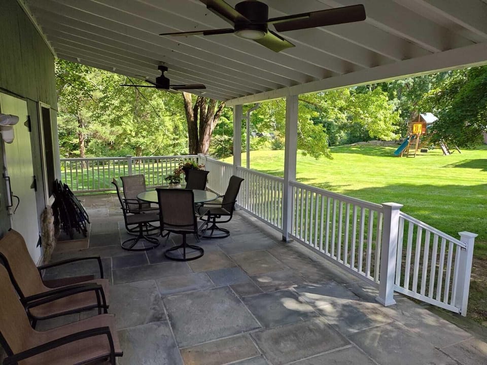 Large wrap-around covered porch with fans