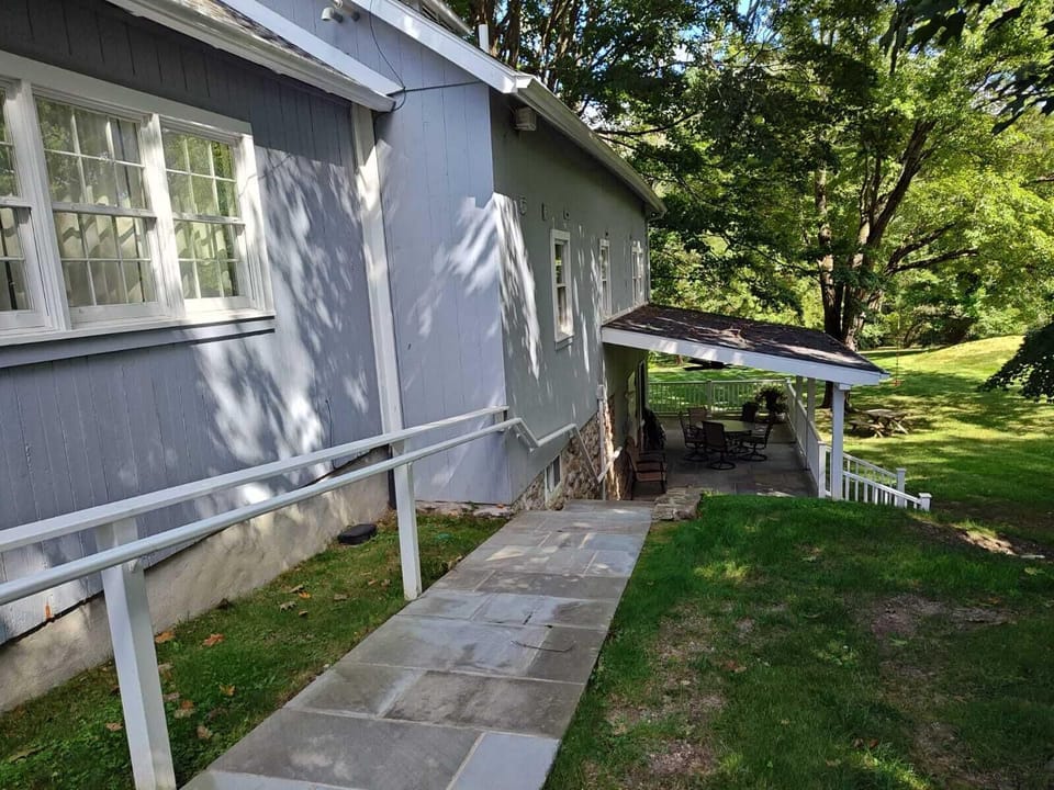 Path from driveway connecting the porch and lower level "studio apartment"