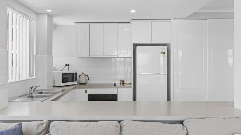 Fully Equipped Kitchen with a View of the Lounge
