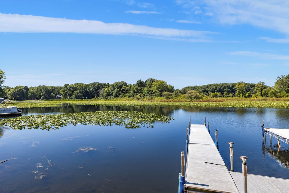 Docks and kayaks with chairs facing the lakes and lake access