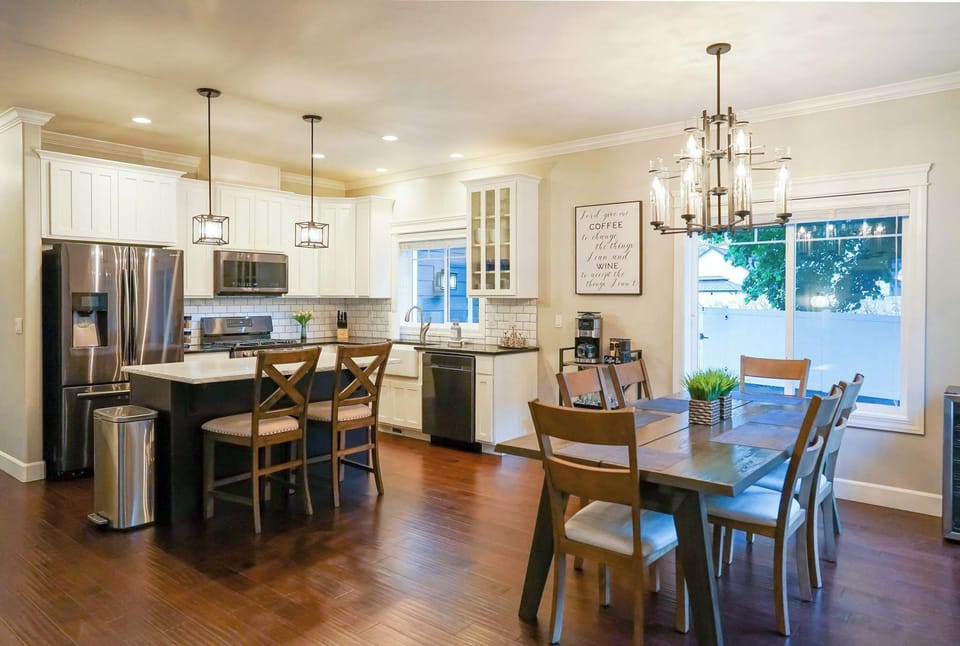 Modern kitchen with stainless appliances + quartz counters.