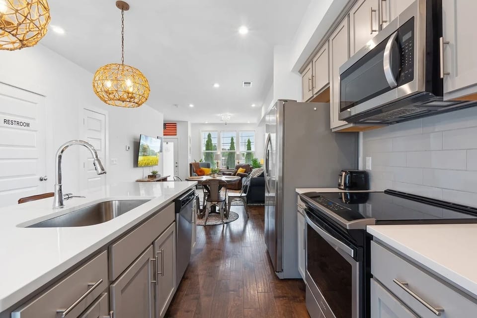 Full stainless steel kitchen and island with seating for two