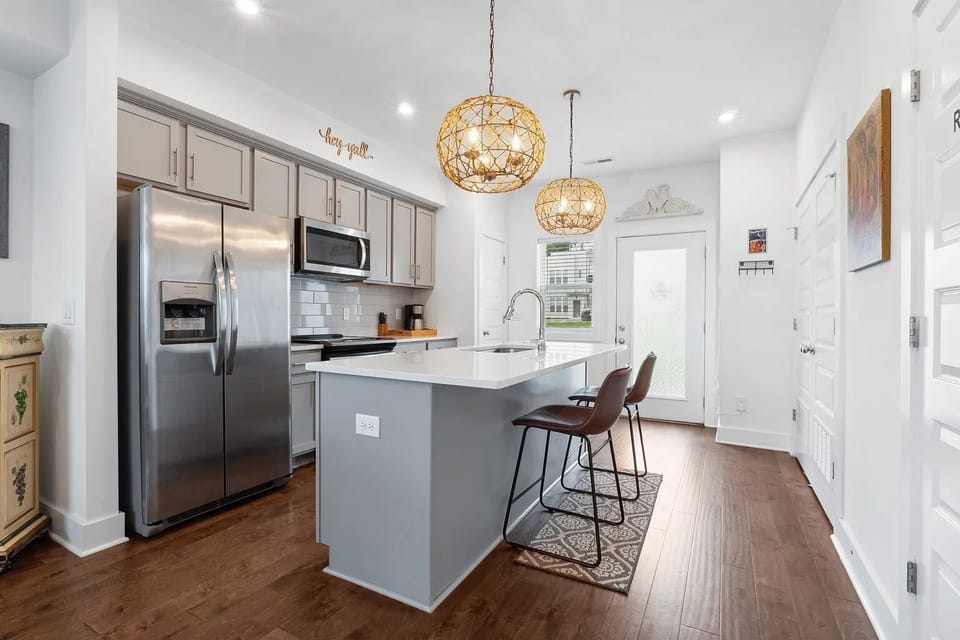 Full stainless steel kitchen and island with seating for two