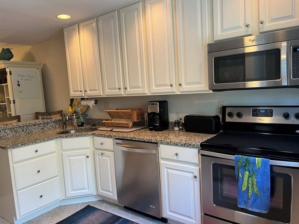 Kitchen complete with dishwasher, microwave, oven, & refrigerator w/icemaker