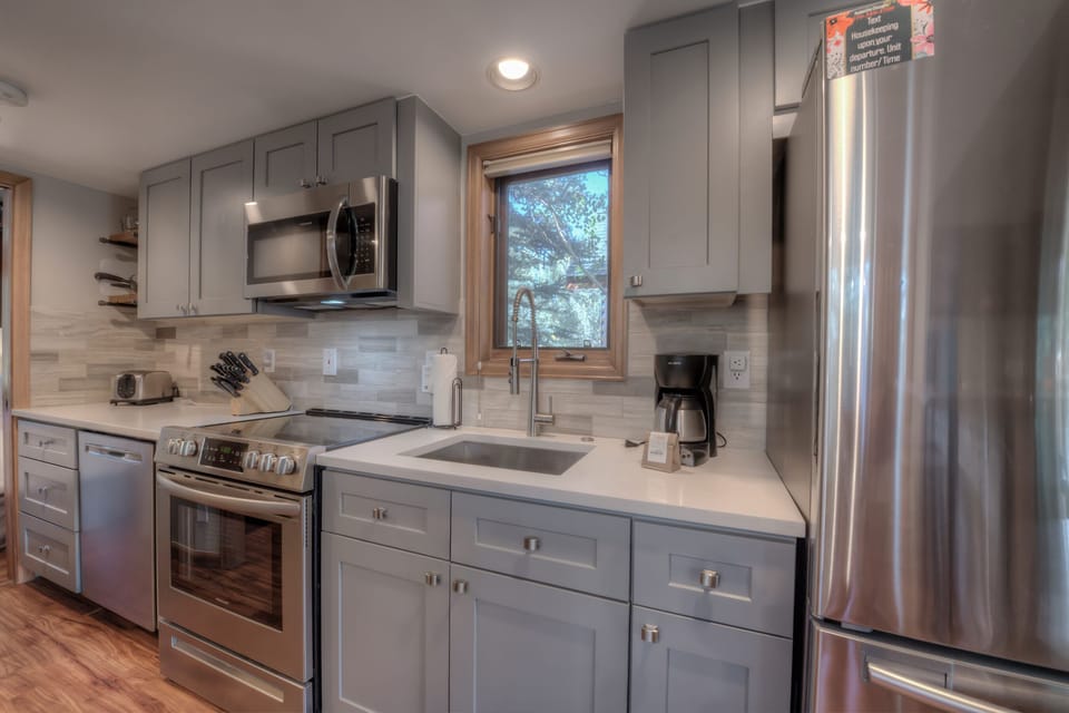 Kitchen with toaster, drip coffee maker, blender, slow cooker and more