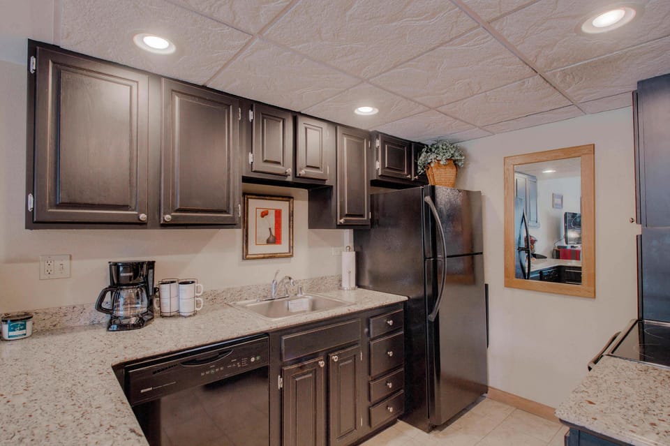Kitchen with drip coffee pot, electric stovetop, toaster and more