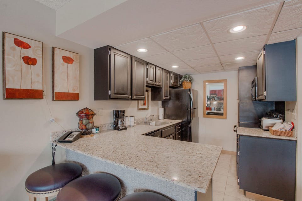 Kitchen with drip coffee pot, electric stovetop, toaster and more