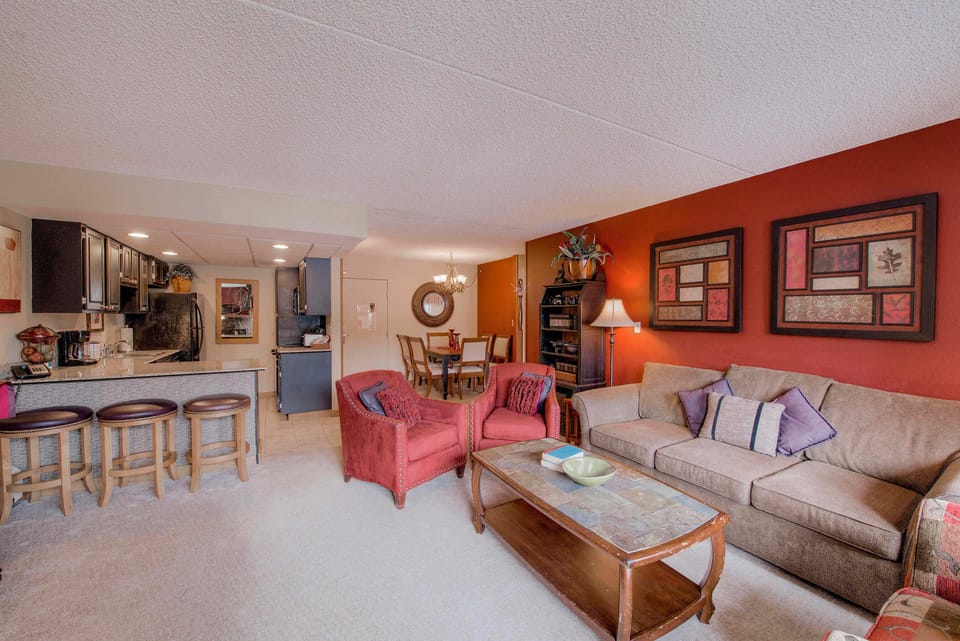 Living room with fireplace, TV and balcony access
