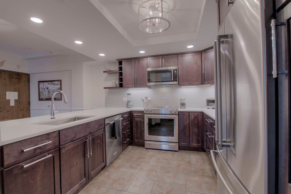 Kitchen with drip coffee maker, blender, slow cooker, toaster oven and more