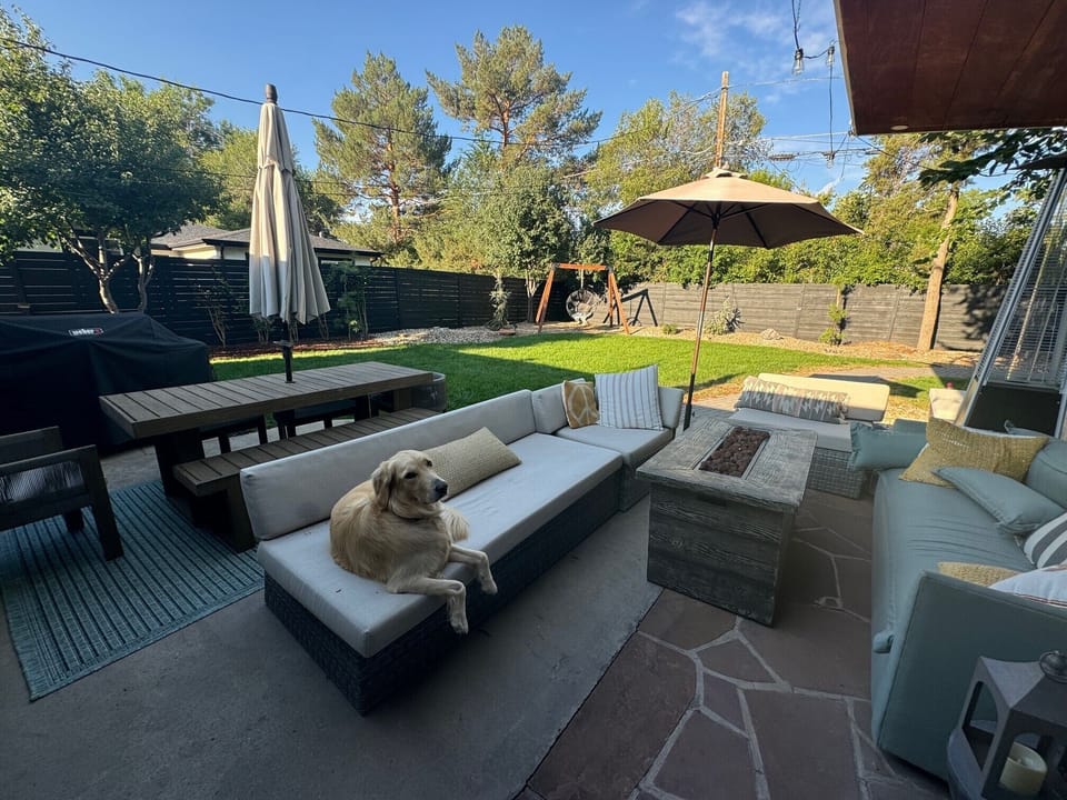 Lots of seating. TV, fire table, anthro outdoor sofa, gas grill, swing chair!
