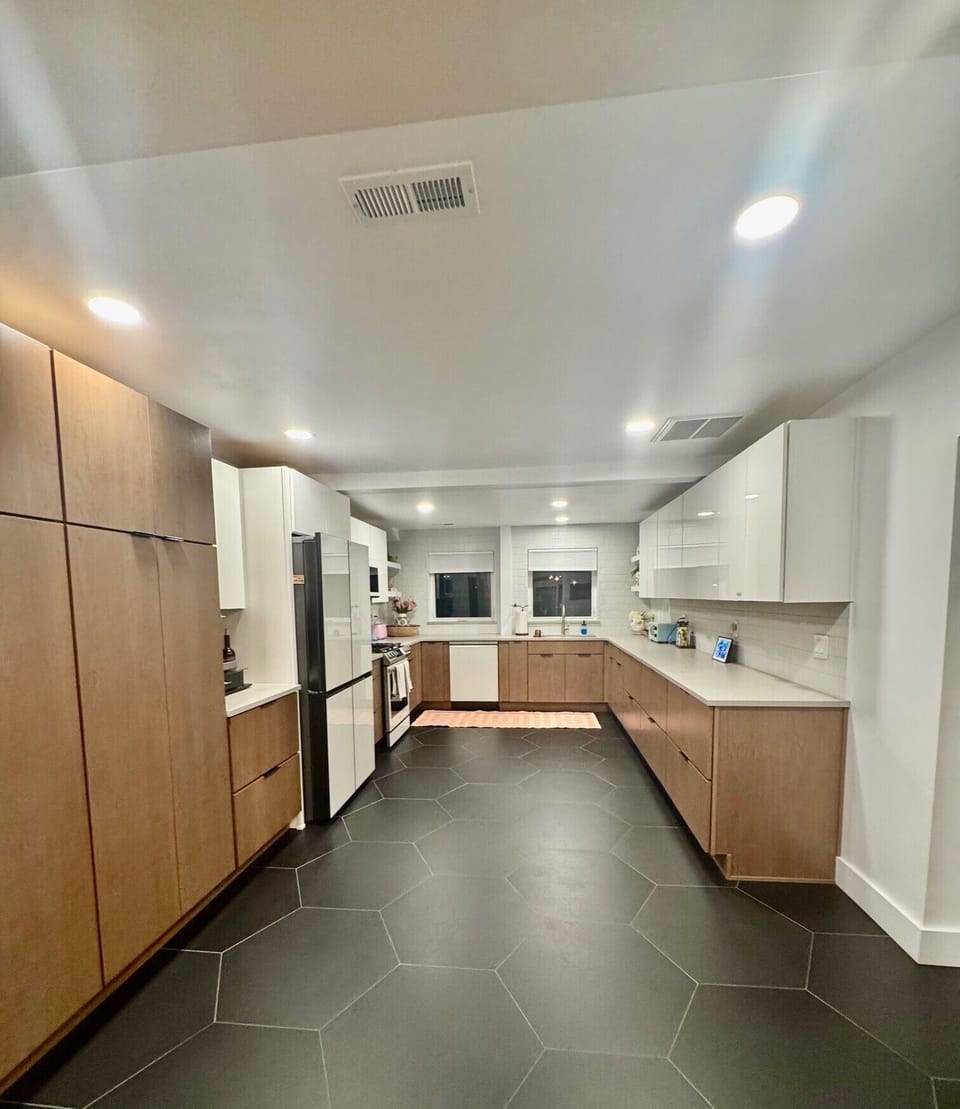 Huge kitchen with every gadget, pots and pans, samsung appliances.