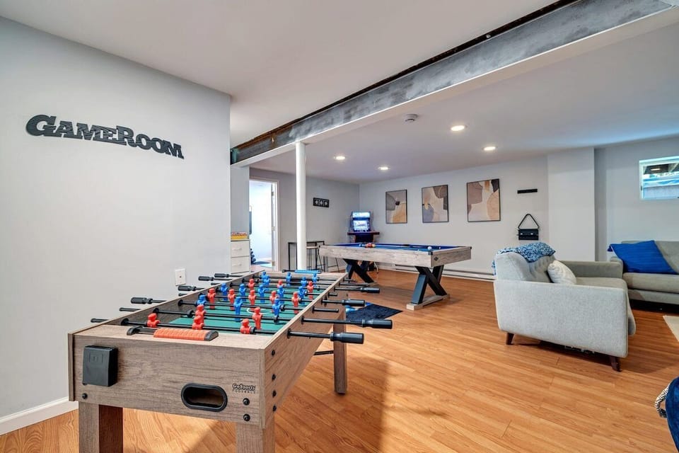  This game room is a haven of fun, complete with a foosball table, pool table, and an X-men arcade machine. Amazing!