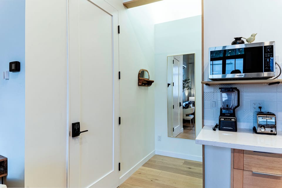The entry to the bedroom with full length mirror. 