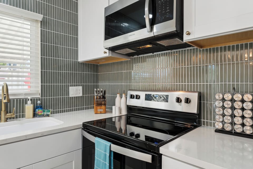 Kitchen view with the upgraded stove and microwave in focus.