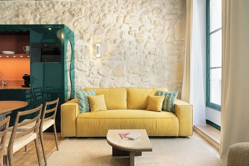 The living area features a comfortable sofa bed and a connected TV