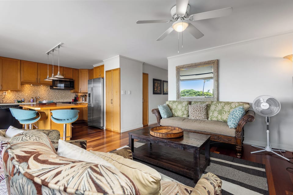 Unwind in your open-concept retreat with island-style charm. Tropical breezes flow through while you relax on plush seating, cook in your fully-equipped kitchen, and soak in lush garden views.