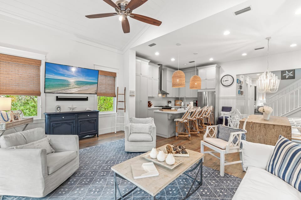 Relax in this bright, coastal-inspired living space with open kitchen, perfect for gathering with loved ones.