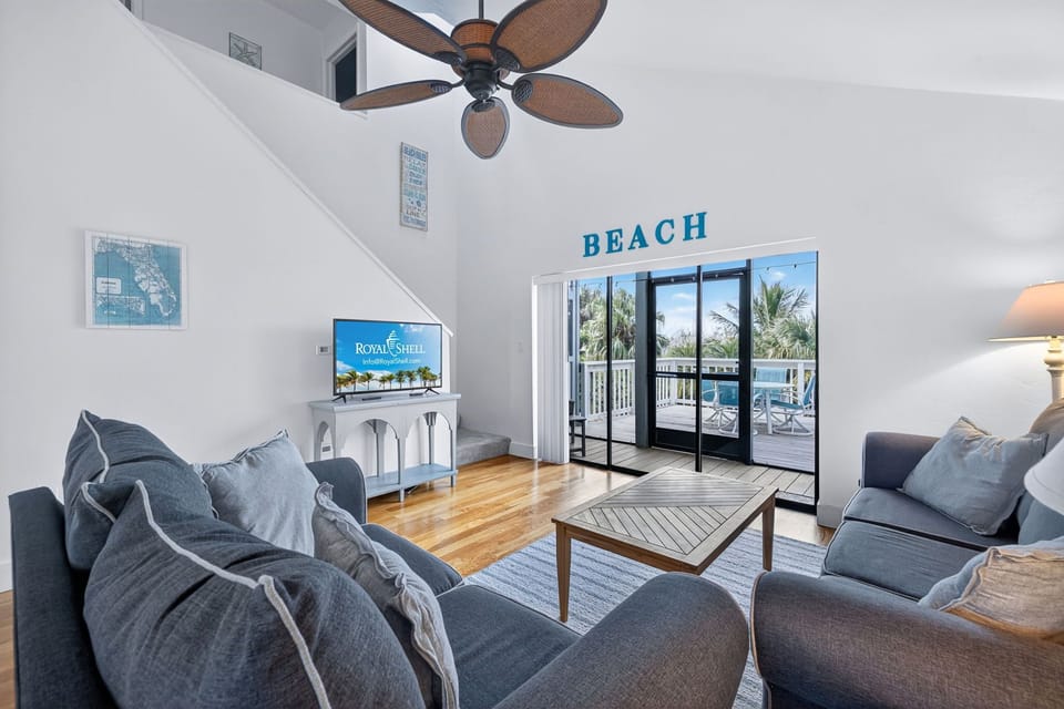 Bright, spacious living area with vaulted ceilings and slider access to private balcony