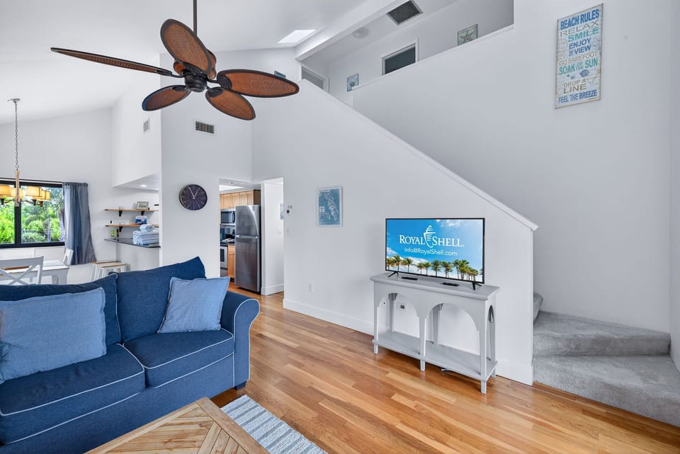 Bright, spacious living area with vaulted ceilings and slider access to private balcony