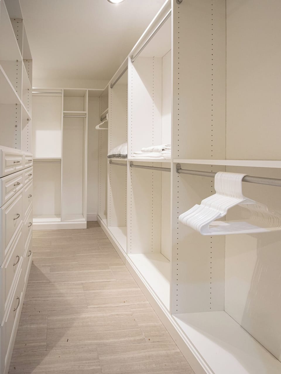 The large designer closet is equipped with built-in shelves and drawers, providing plenty of storage space.