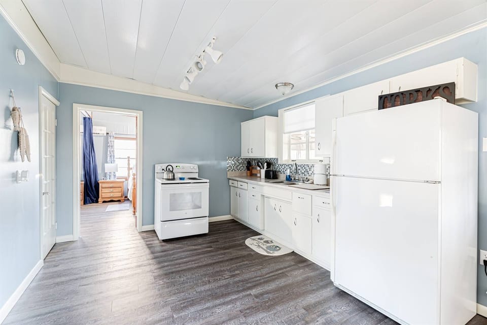 Our simple kitchen has an electric stove and all the cooking things you need. There is also a slow cooker.  The exterior has a BBQ grill on a propane tank.  Not shown is the coffee bar.