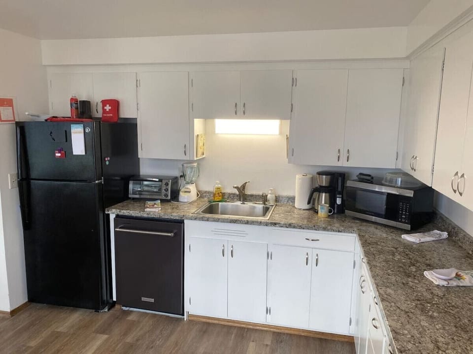 A full size refrigerator with freezer will meet all your needs, along with a microwave, coffee maker and toaster oven!