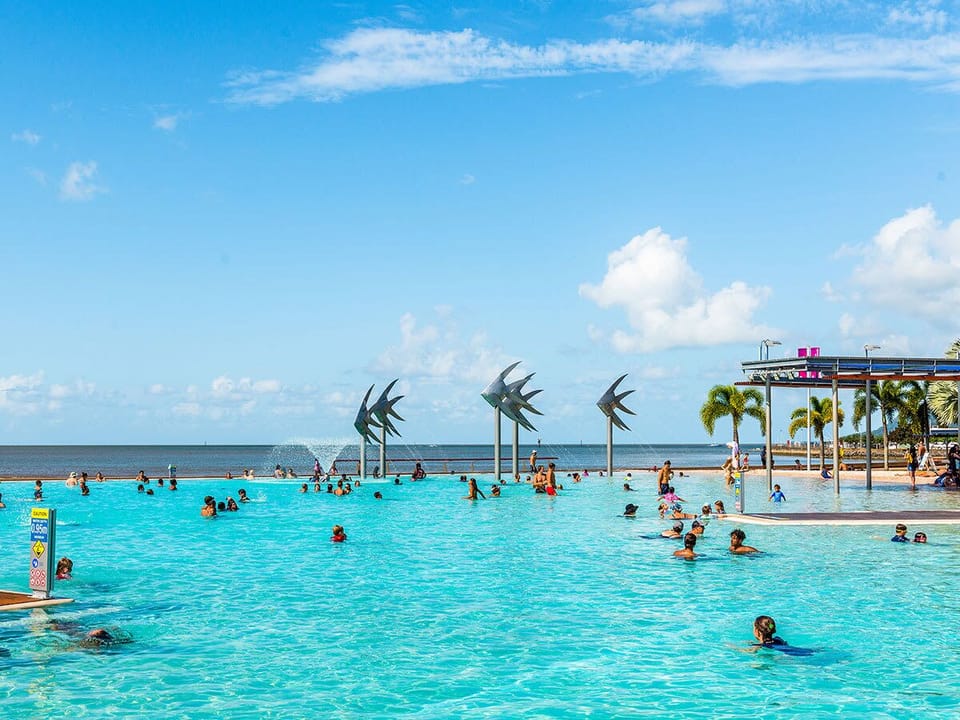 Spend warm afternoons at the Cairns Esplanade Lagoon, a stunning saltwater swimming spot framed by grassy lawns, palm trees and relaxed waterfront views.
