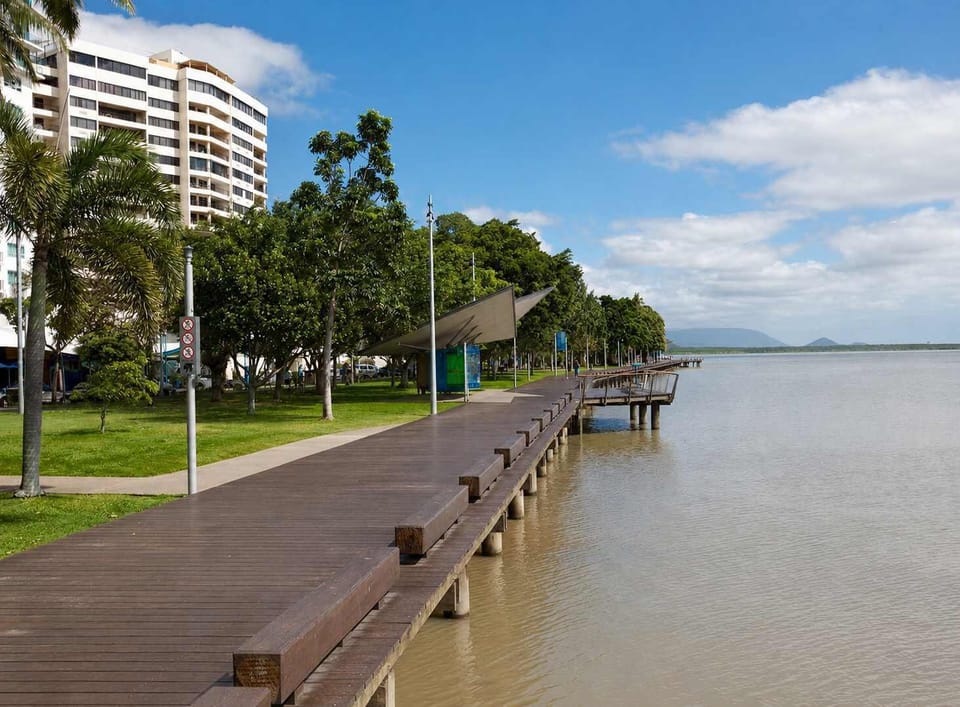 Walk along the Cairns Esplanade boardwalk, perfect for sunrise strolls, morning jogs, and relaxed evening walks with sweeping water and mountain views.