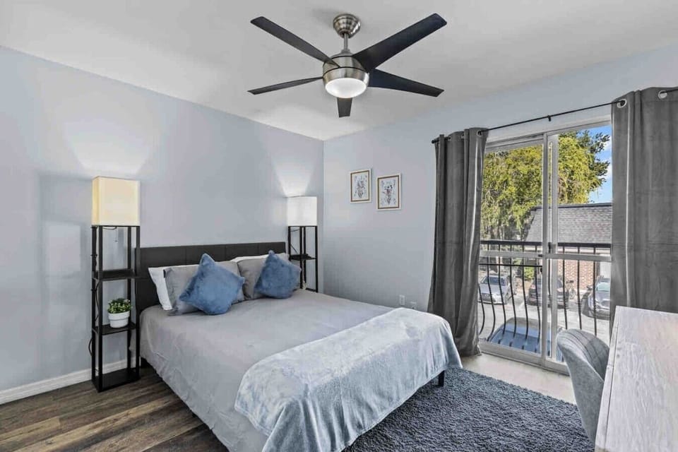 Queen size bed with two nightstands and outlet chargers within them.