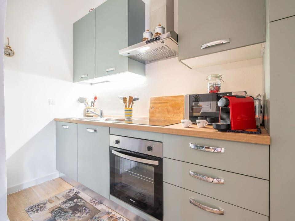Countertop, Cabinetry, Building, Drawer, Kitchen Stove, Kitchen, Kitchen Appliance, Wood, Lighting, Interior Design