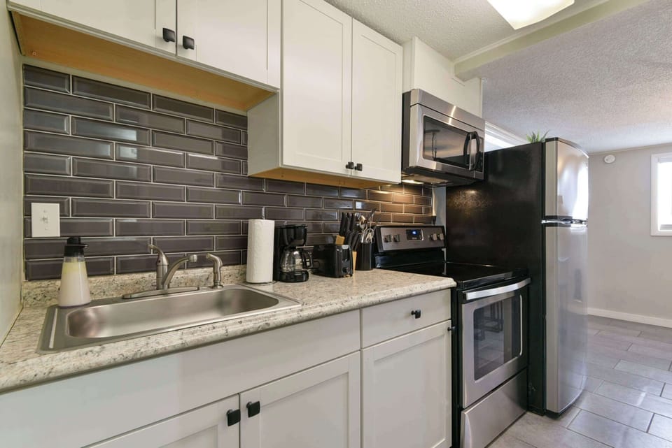 The kitchen is narrow but is stocked with essential appliances