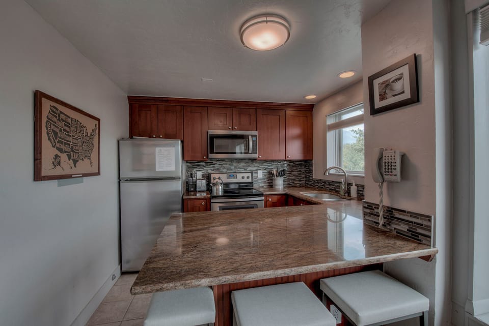 Kitchen with drip coffee maker, toaster, blender, slow cooker, and more