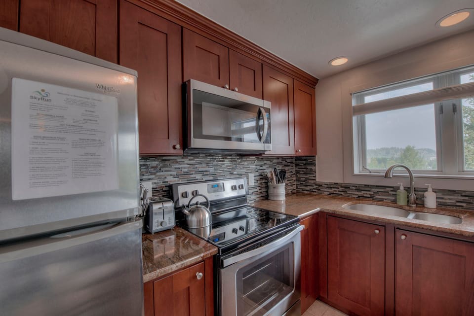Kitchen with drip coffee maker, toaster, blender, slow cooker, and more
