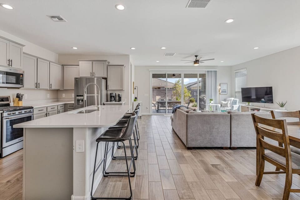 A stunning open-concept kitchen and dining area with modern finishes, stainless steel appliances, and bar seating.