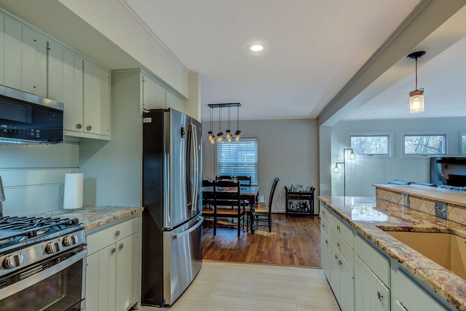 Kitchen is equipped with a double oven, large Frig/Freezer and island bar