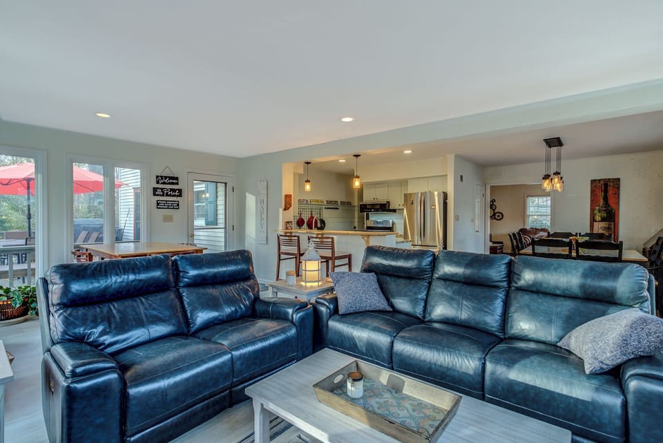 View of sunroom facing into open kitchen and main eating space