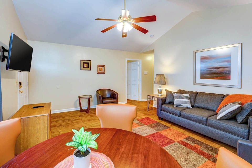 Cozy living space with sofa sleeper, table, and TV